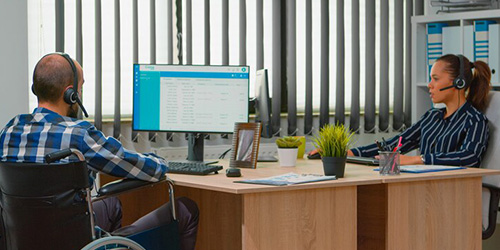 A person with a disability using a computer during a job training session in Perth, WA for employment support.